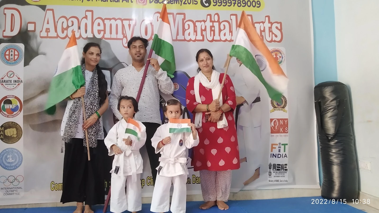 Students and families with Indian flags at D Academy
