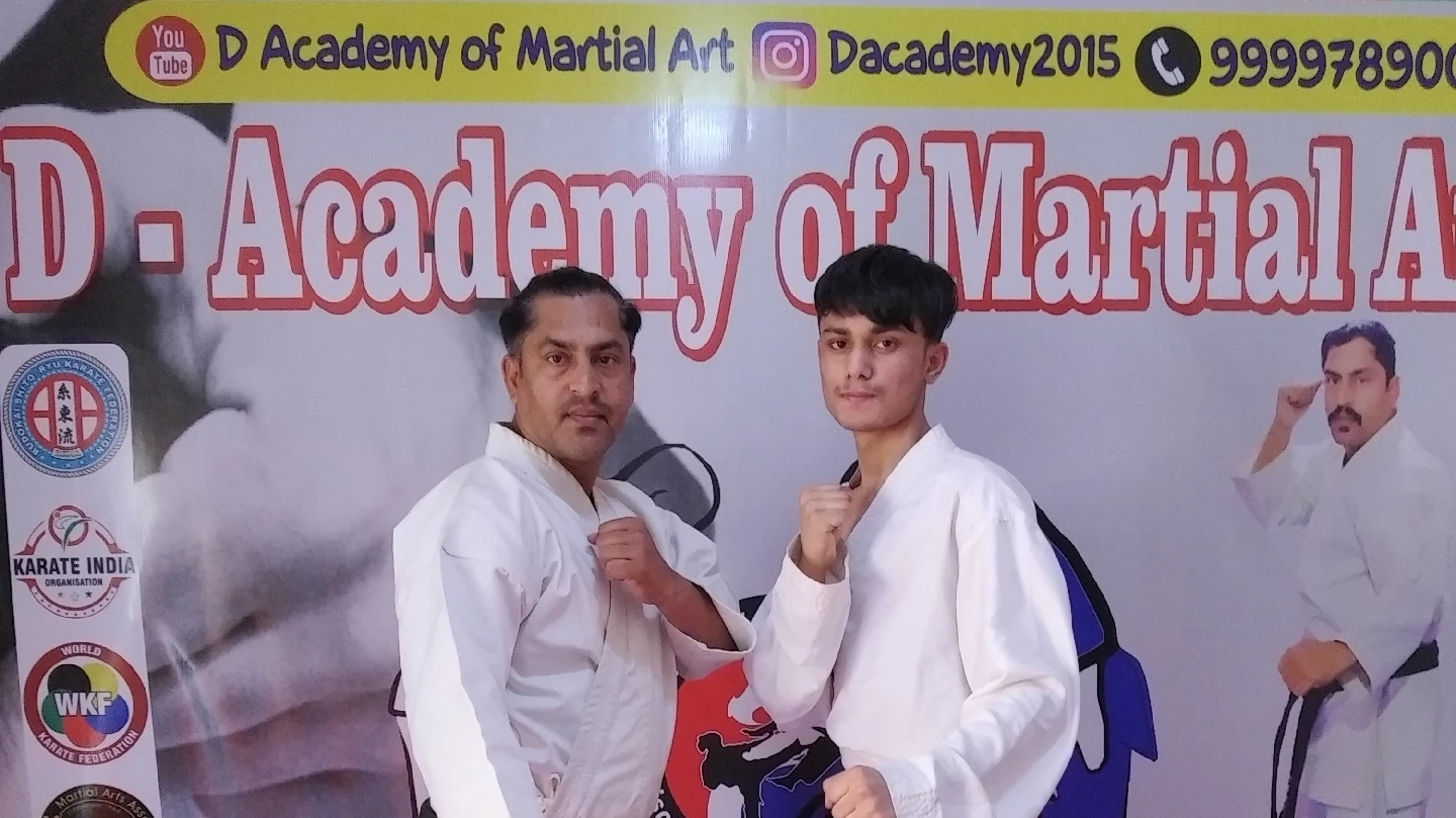 Instructor and student in karate uniforms at D Academy